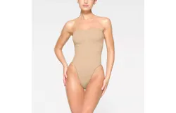 Skims Seamless Sculpt Strapless Thong Bodysuit In Sand